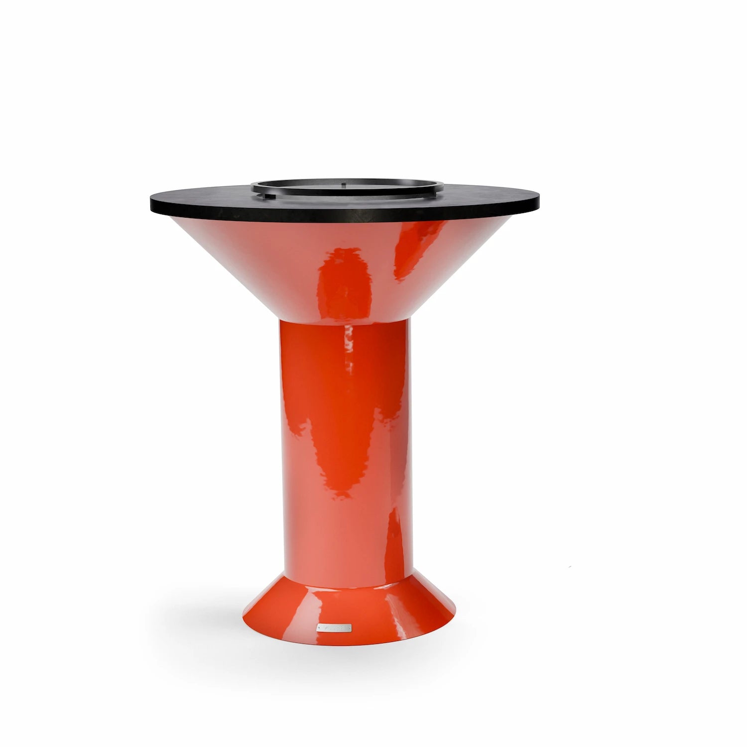 a carbon steel ring with 3 little feet that is placed on the cooking plate of a dark orange Vuuris grill as a bumper to ensure food does not slide into opening