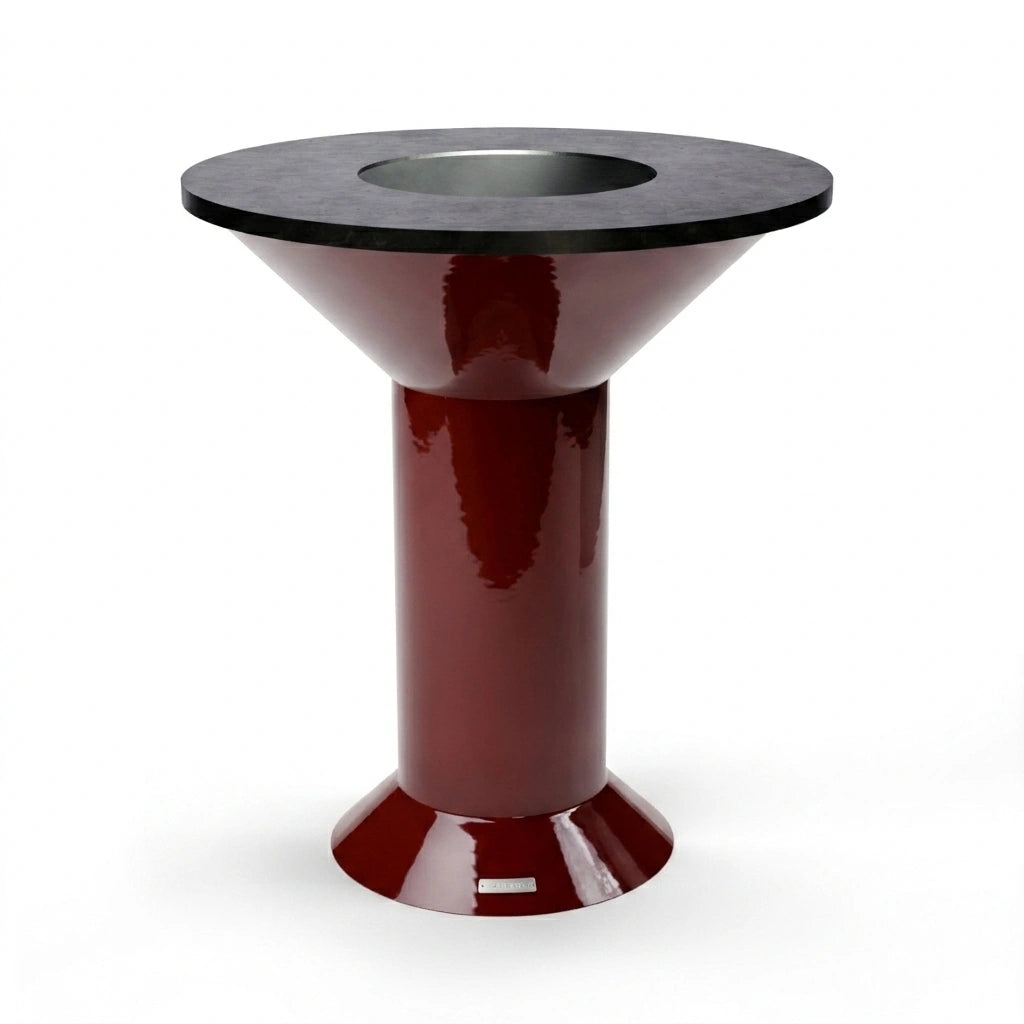 Vuuris Garnet outdoor fire pit centerpiece in bordeaux porcelain enamel, mounted on the large base at counter height with the 8mm carbon steel cooking plate
